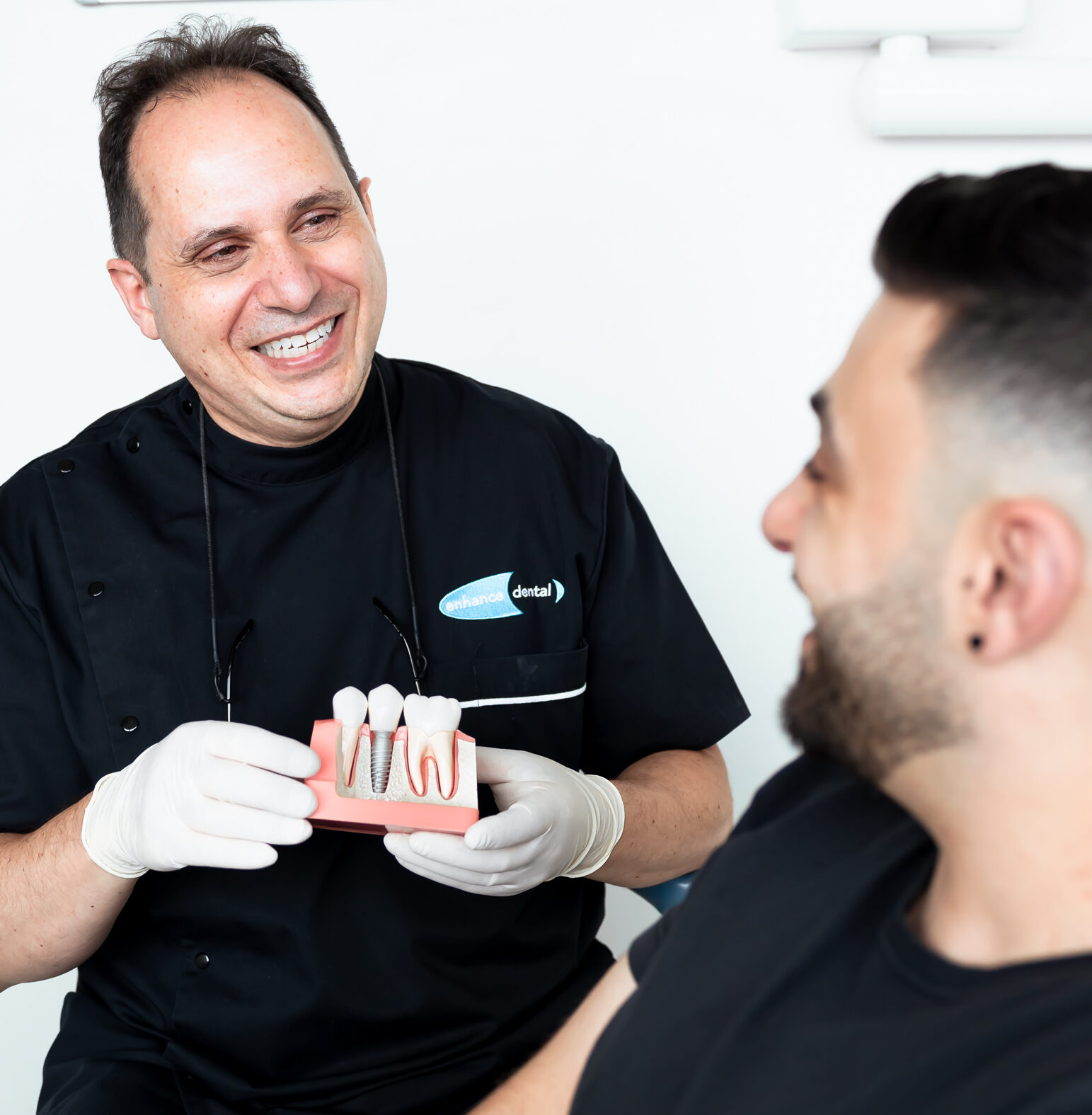 Dr Joseph Paino talking with a patient at Enhance Dental