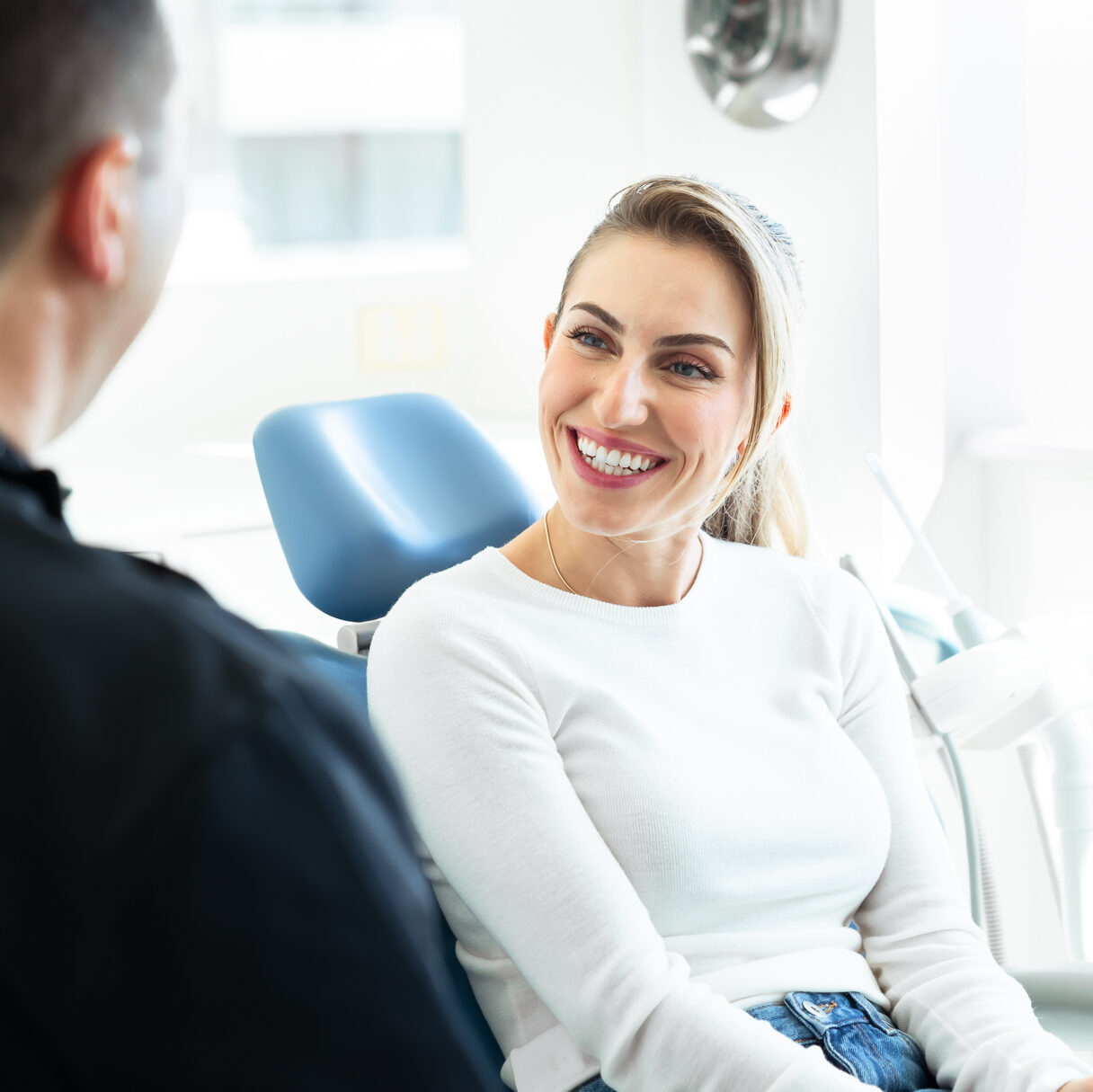 A patient smiling in the dental chair at Enhance Dental