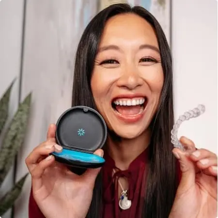 Woman holding an Invisalign storage case and aligner